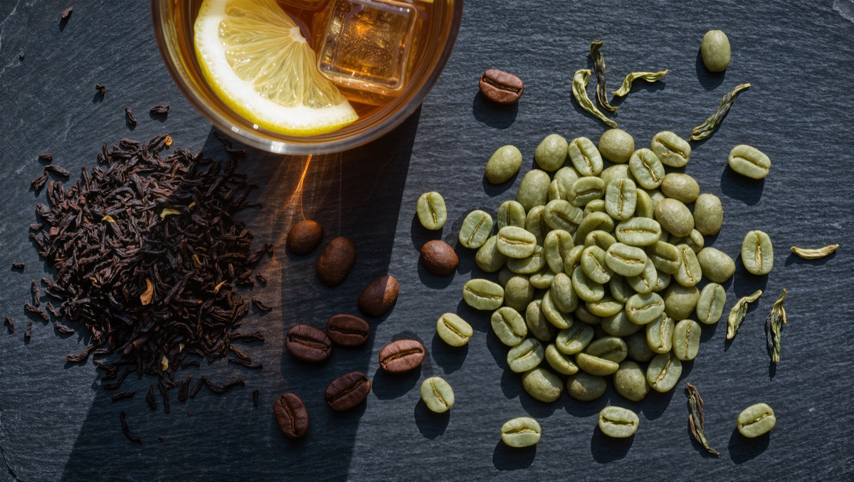 Black tea leaves, iced tea with lemon, and raw green coffee beans on slate